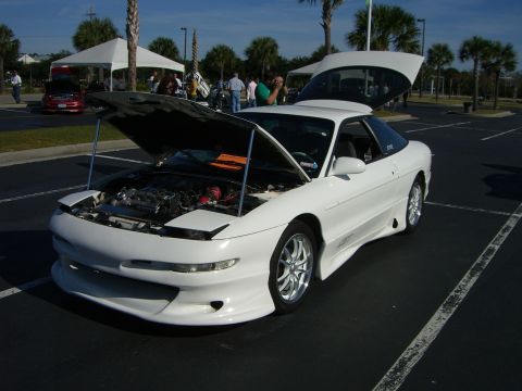 1996 Ford Probe - A white 1996 Ford Probe is displayed with its hood and trunk open, revealing the engine compartment.