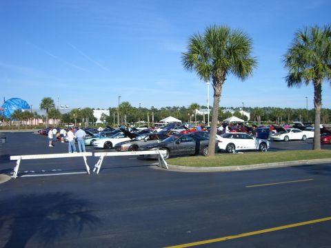 1996 Ford Probe - A gathering of sports cars in a parking lot on a sunny day.