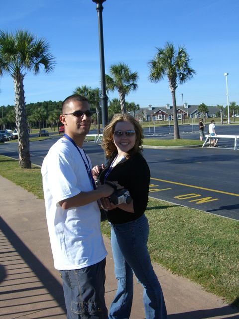 1996 Ford Probe - A man and woman pose for a photo in a sunny outdoor setting with palm trees and buildings visible.