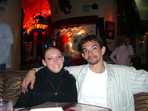 1996 Ford Probe - A couple poses for a photo inside a restaurant with a 'Planet Hollywood' sign visible.