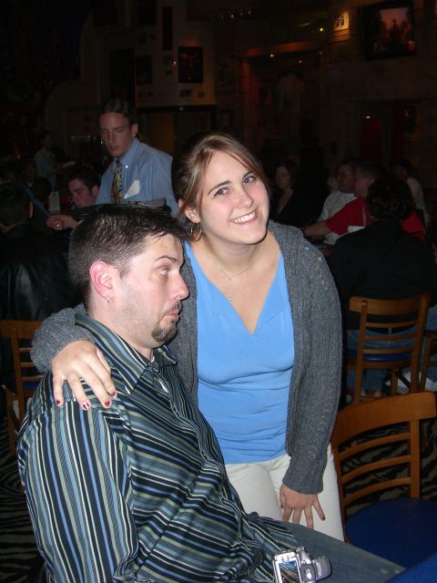 1996 Ford Probe - A couple poses for a photo in a bar, with other people visible in the background.