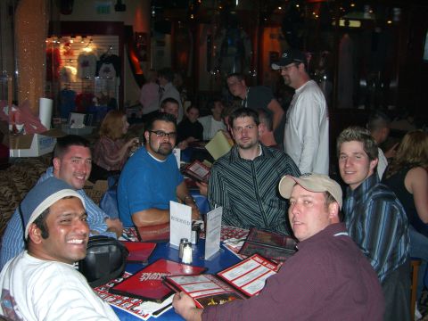 1996 Ford Probe - Several men are seated around a table at a restaurant, with menus open in front of them.