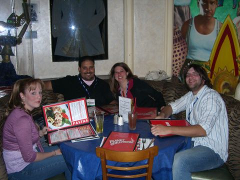 1996 Ford Probe - A group enjoys a meal at Planet Hollywood, with menus open and drinks on the table.