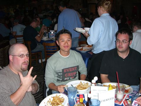 1996 Ford Probe - People gathered at tables in a restaurant setting, with food and drinks on the tables.