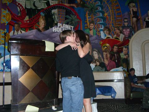1996 Ford Probe - A couple shares a kiss in front of a vibrant mural at Planet Hollywood.