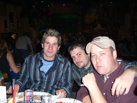 1996 Ford Probe - A group of friends gathered around a table, enjoying a meal and drinks in a dimly lit establishment.