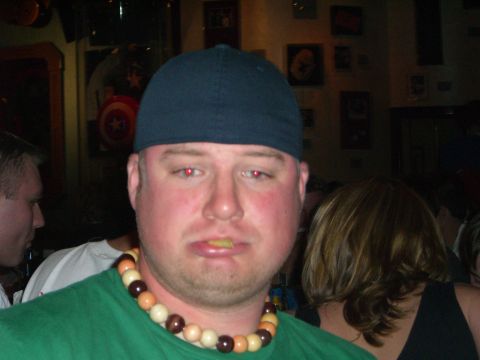 1996 Ford Probe - A man with a chip in his mouth and a beaded necklace poses for a photo indoors.