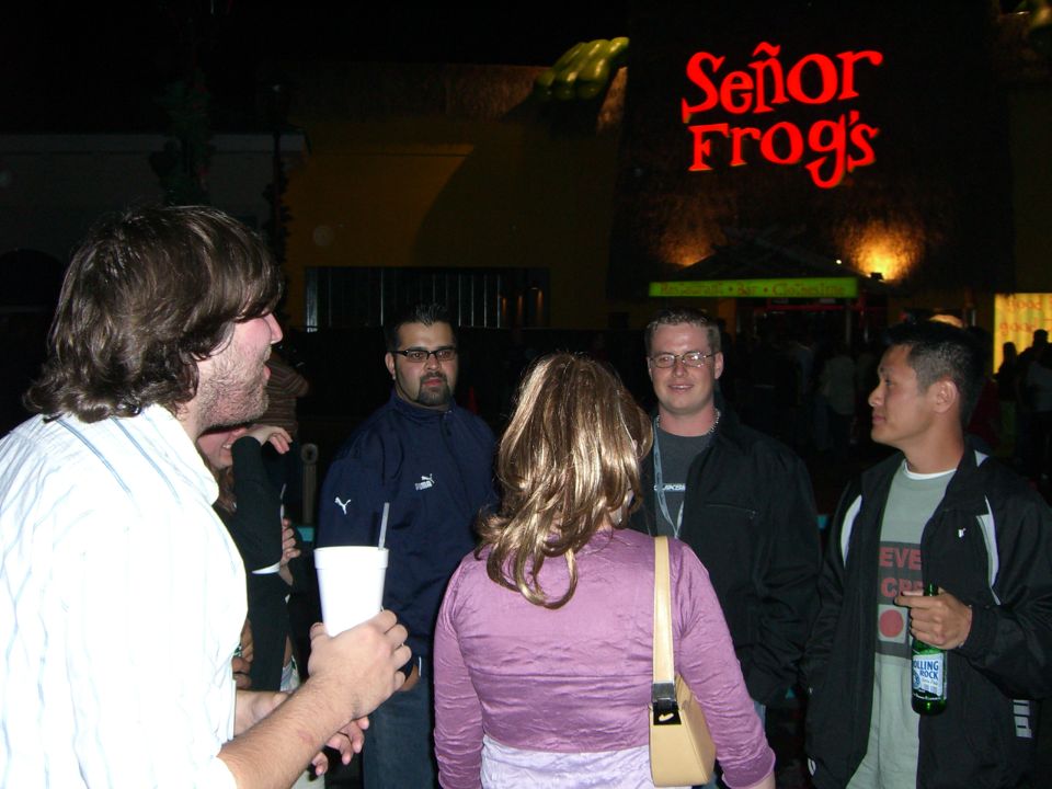 Group of people standing outside Señor Frog's at night