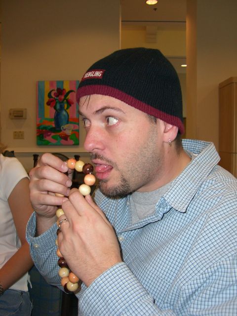 1996 Ford Probe - A man with a beanie and a string of beads is shown in this indoor scene.