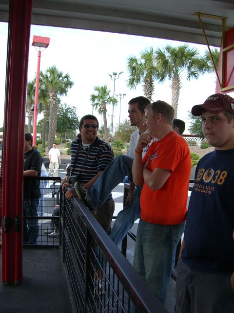 1996 Ford Probe - Several young men are gathered together outdoors, with palm trees visible in the background.