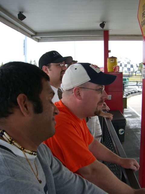 1996 Ford Probe - Spectators observe a race from a viewing area, with a go-kart track in the distance.