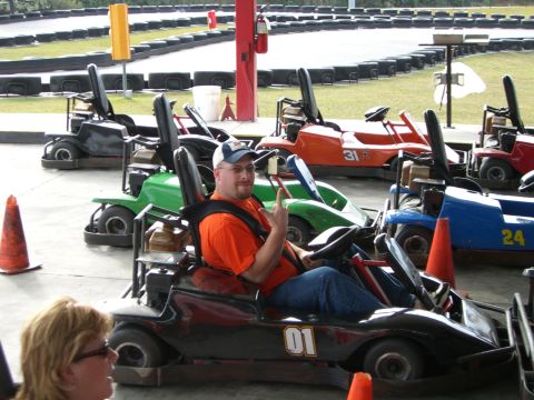 1996 Ford Probe - A man poses in a go-kart at an outdoor track, with several other karts visible in the background.
