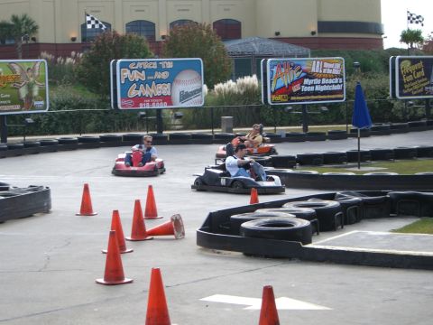 1996 Ford Probe - Go-karts navigate a track with various advertisements visible in the background.
