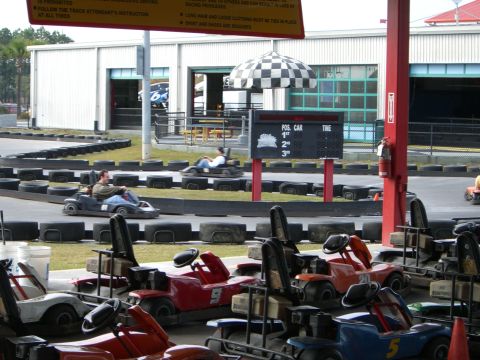 1996 Ford Probe - Go-karts are lined up and in use on a track at an amusement park.