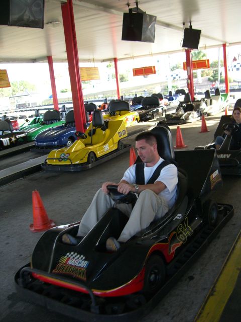 1996 Ford Probe - Go-karts lined up at a speed park, with a man in the foreground.