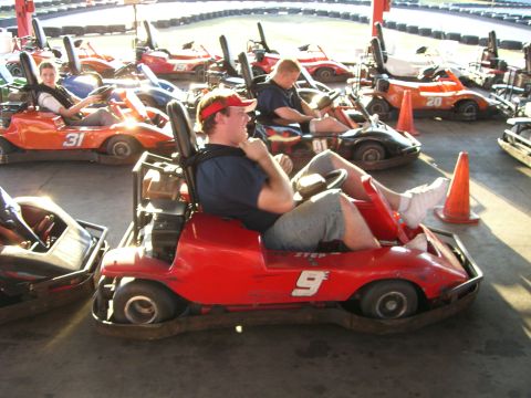 1996 Ford Probe - Go-karts lined up at a track, with drivers seated and ready to race.