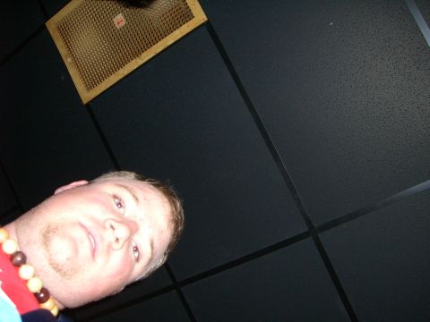 1996 Ford Probe - A man is looking upwards towards a ceiling vent, wearing a necklace.