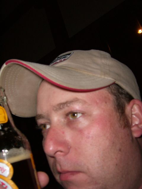 1996 Ford Probe - A man in a baseball cap holds a bottle of soda, his face partially obscured.