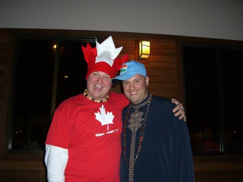 1996 Ford Probe - Two men dressed in festive attire, one wearing a Canadian-themed outfit, pose for a photo.