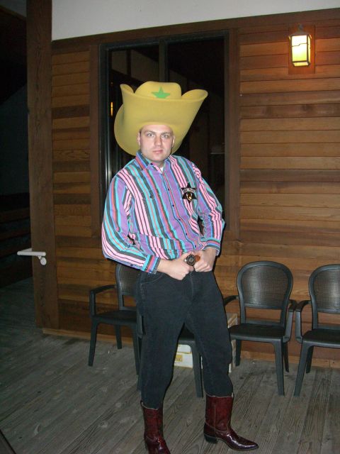 1996 Ford Probe - A man dressed as a cowboy poses for a photo on a wooden porch.