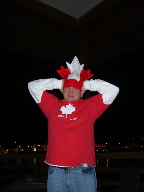 1996 Ford Probe - A man proudly displays his Canadian spirit with a maple leaf hat and t-shirt, hands on his head.