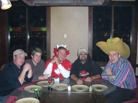 1996 Ford Probe - A group of friends are seated at a table, some wearing novelty hats, in what appears to be a restaurant.