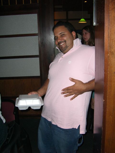 1996 Ford Probe - A man smiles while holding a white takeout container and resting his hand on his stomach.