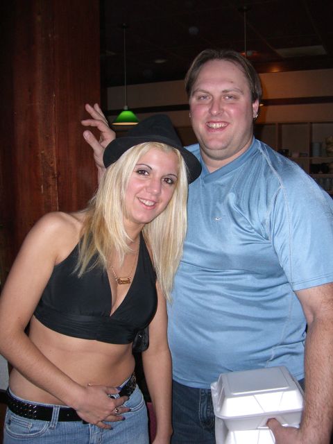 1996 Ford Probe - A couple poses for a photo indoors, with the woman wearing a hat and the man holding a food container.