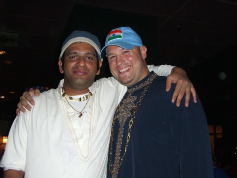 1996 Ford Probe - Two men smile for a photo, one wearing a blue cap with an Indian flag and the other a white cap.