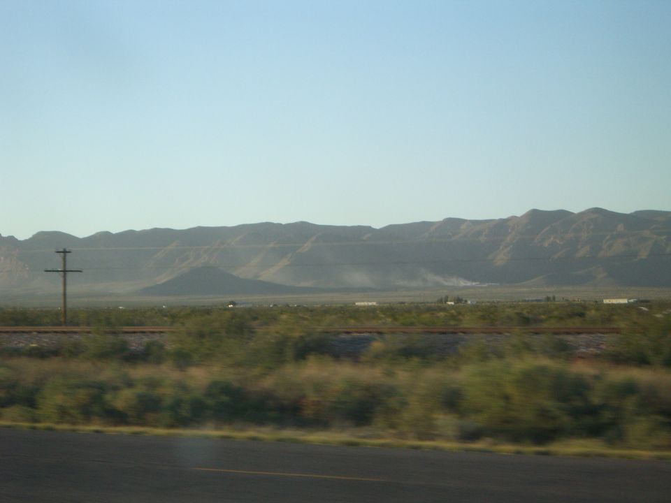 Desert landscape with mountains and railroad tracks