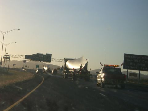 1996 Ford Probe - Oversized load being transported on a highway with an escort vehicle.