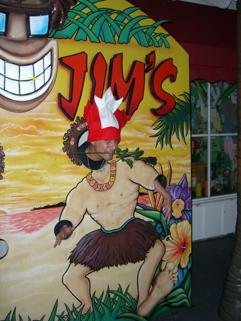 1996 Ford Probe - A person poses in a tropical-themed photo booth cutout with "Jim's" text visible.