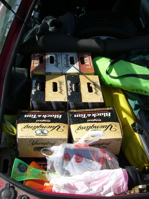 1996 Ford Probe - The trunk of a car is filled with six crates of Yuengling beer, luggage, and other items.