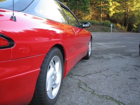 1996 Ford Probe - Red 1996 Ford Probe parked on an asphalt surface with trees in the background.