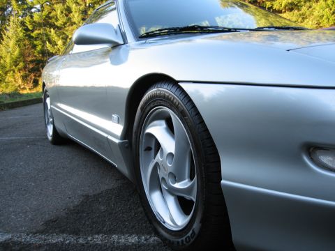 1996 Ford Probe - A silver car is parked outdoors, with trees visible in the background and asphalt in the foreground.