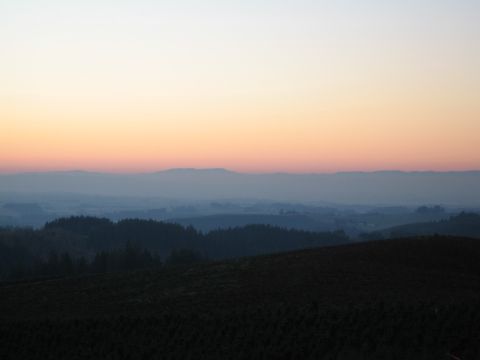 1996 Ford Probe - Sunset over rolling hills and distant mountains, with a gradient sky from yellow to pink to blue.