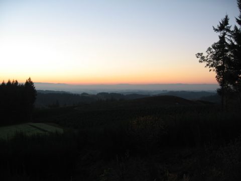 1996 Ford Probe - The sky shows a gradient of orange and blue as the sun sets over rolling hills.