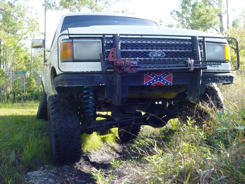 1989 Ford Bronco - This 1989 Ford Bronco is equipped with a heavy-duty brush guard and a prominent Confederate flag sticker on the front bumper.
