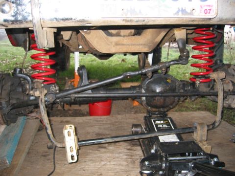 1991 Ford Explorer - Close-up view of the front axle and suspension system, likely during a modification or repair.