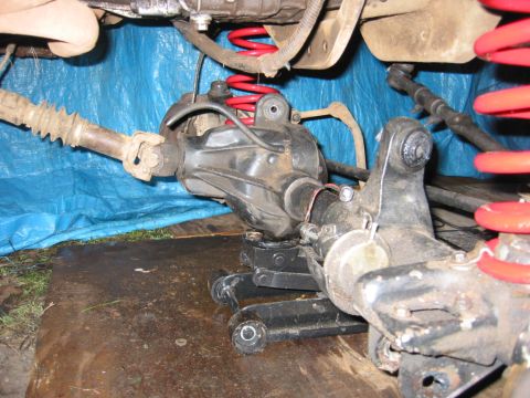 1991 Ford Explorer - Close-up view of a vehicle's rear axle and suspension components during a modification.