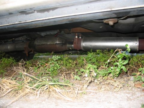1985 Ford Crown Victoria LTD - The exhaust system, including a catalytic converter, is visible beneath a vehicle.