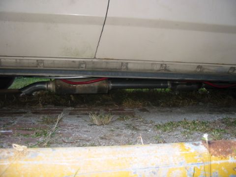 1985 Ford Crown Victoria LTD - The exhaust system, including the muffler and piping, is visible beneath the vehicle's body.