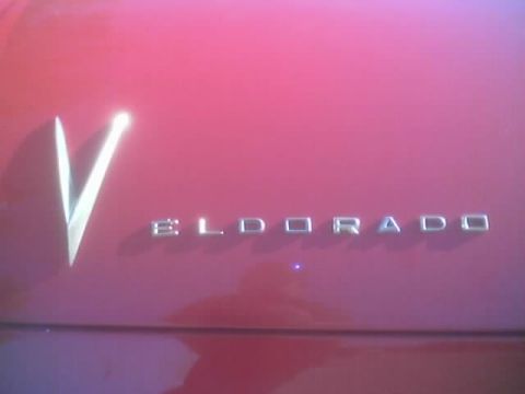 1968 Ford Mustang - Close-up of the Eldorado script and V emblem on a red vehicle.