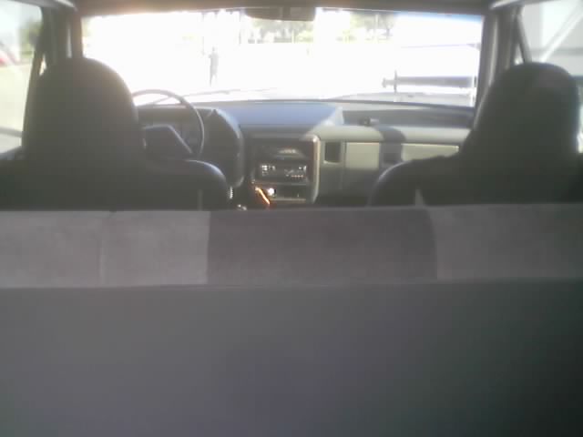 Dashboard and front seats of a truck seen from the rear cargo area