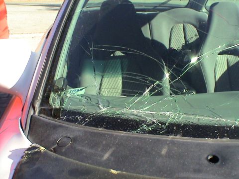 1997 Ford Probe - The windshield of a car is heavily cracked, obscuring the interior seats and dashboard.