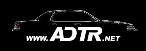 1998 Ford Crown Victoria - logo graphic showing a white sedan silhouette over a black background with the text www.ADTR.net.