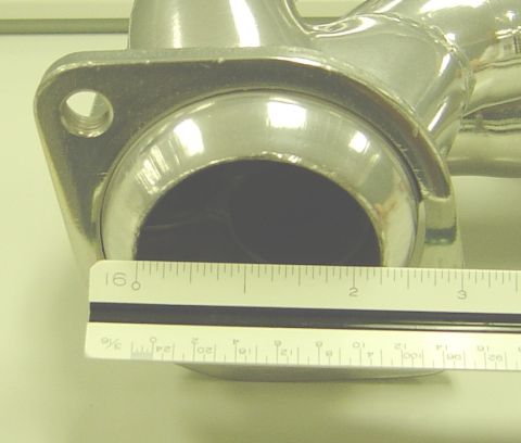 1986 Ford Bronco - Close-up of an exhaust header pipe being measured with a ruler.