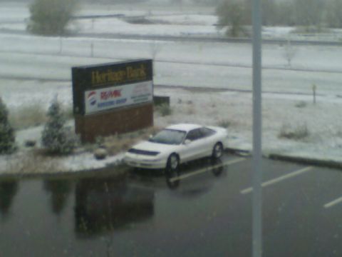1996 Ford Probe - A white 1996 Ford Probe is parked in a lot with light snow falling.