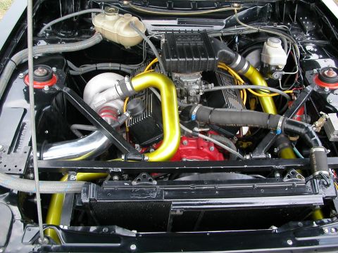 1981 Ford Mustang - The engine bay features a prominent turbocharger and custom yellow piping.