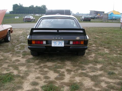 1981 Ford Mustang - This black Ford Capri features a prominent rear spoiler and an Ontario license plate reading '75 JPS'.